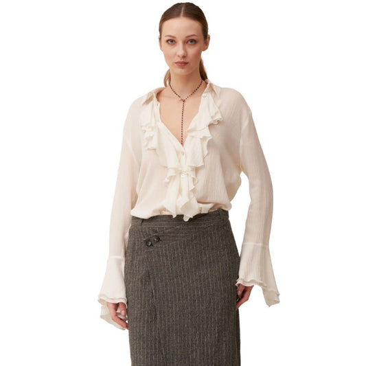 Wool muslin shirt with ruffles and calla cuffs.
